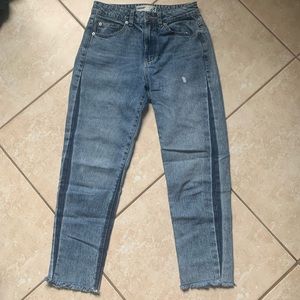 Light washed short mom jeans with dark washed pin stripe. Ruffled bottoms